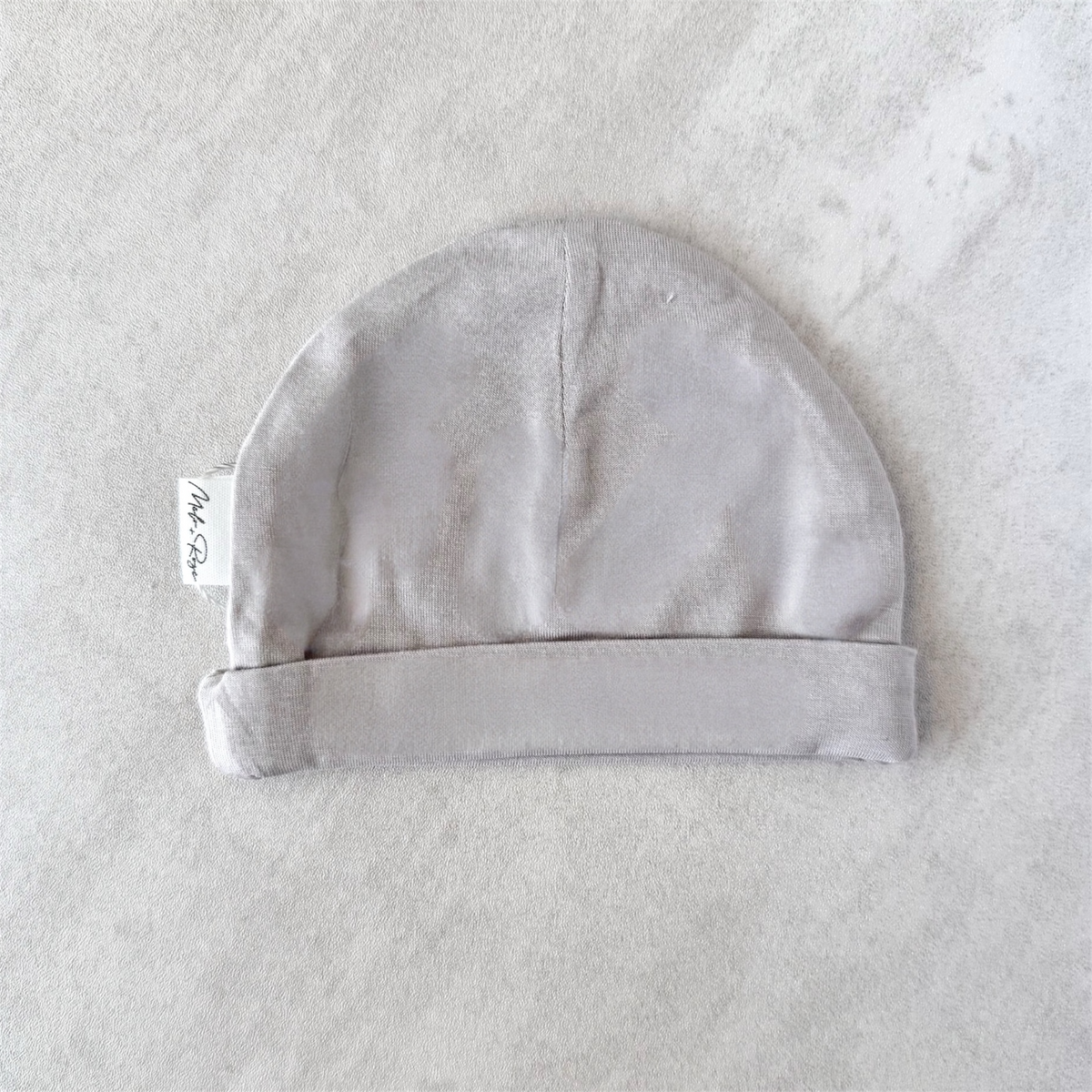 Gray premature baby hat on a light gray background