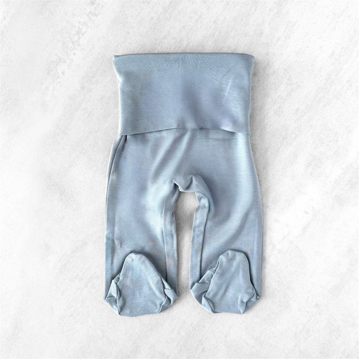 Light blue tiny baby bottoms with footies on a white background