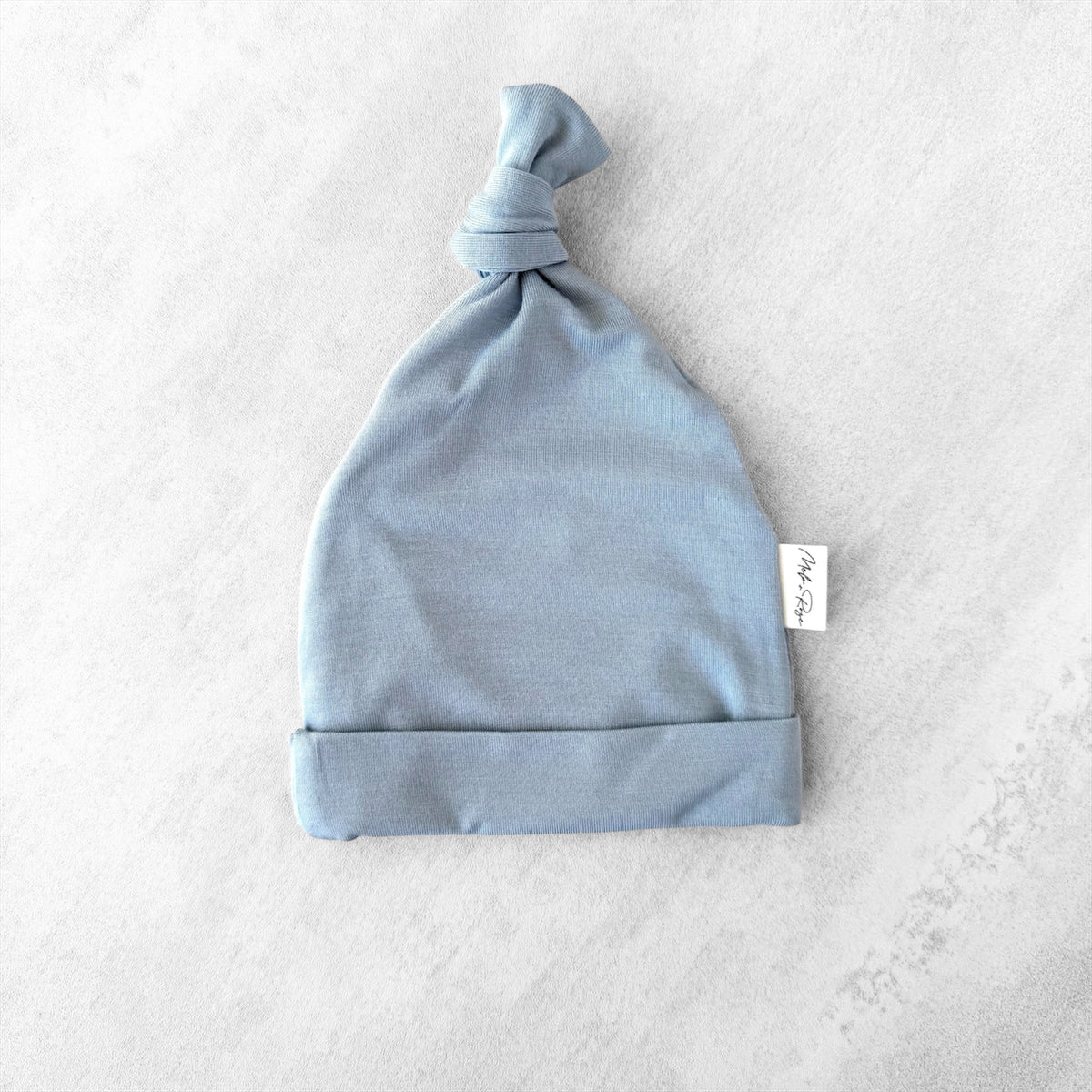 tiny baby blue hat on white background